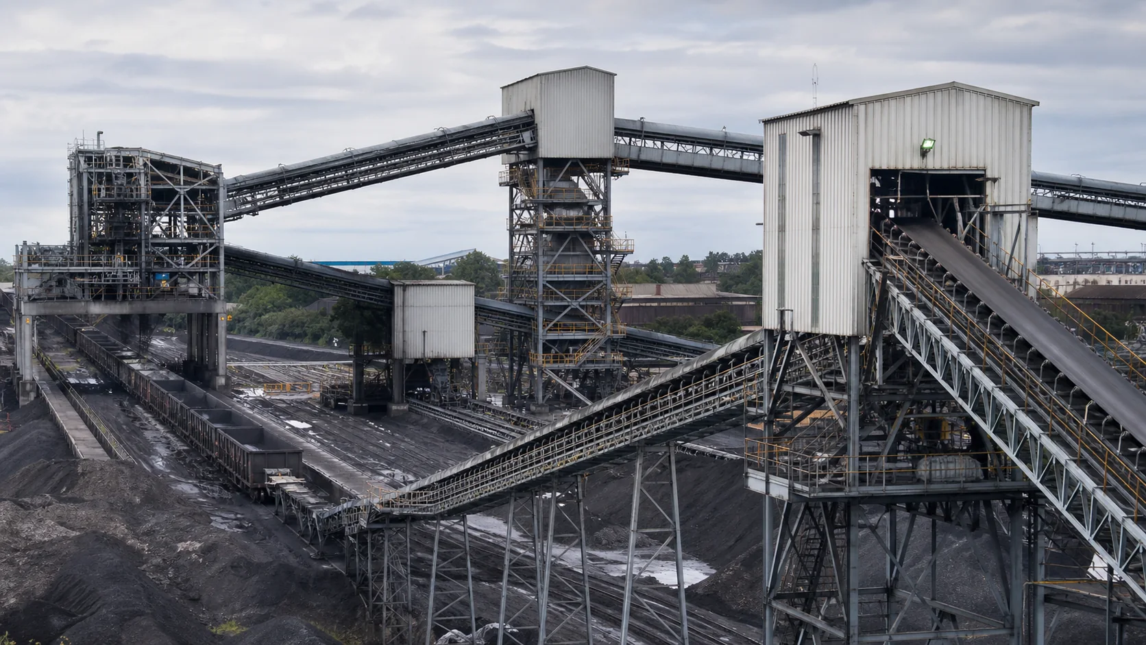 Coal Handling Plant conveyor transfer towers and machinery showing plant-side handling constraints